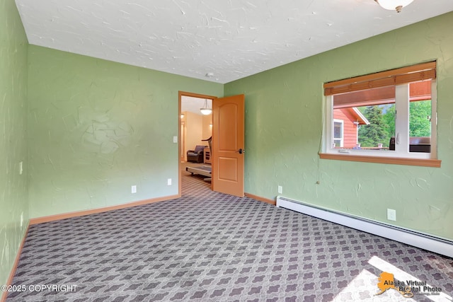 23324 Greatland Dr, Chugiak, AK 99577 - unfurnished room featuring a baseboard radiator and a textured ceiling
