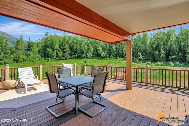 23324 Greatland Dr, Chugiak, AK 99577 - wooden terrace with outdoor dining area and a forest view