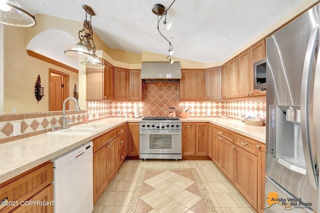 23324 Greatland Dr, Chugiak, AK 99577 - kitchen featuring appliances with stainless steel finishes, exhaust hood, light tile patterned floors, light countertops, and tasteful backsplash