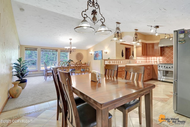 23324 Greatland Dr, Chugiak, AK 99577 - dining room with a chandelier, light tile patterned floors, vaulted ceiling, and light colored carpet