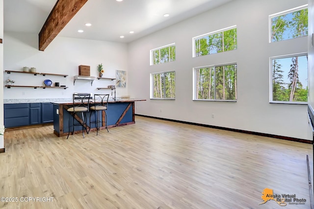 3528 S Mills Ct, Big Lake, AK 99623 - kitchen featuring a kitchen bar, open shelves, a high ceiling, light wood finished floors, and recessed lighting