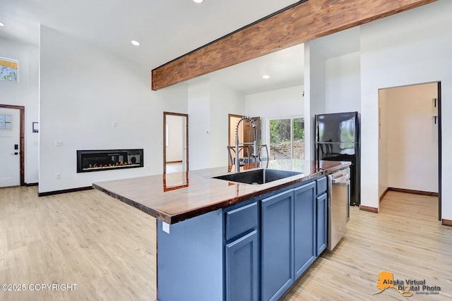 3528 S Mills Ct, Big Lake, AK 99623 - kitchen with light wood-type flooring, dark countertops, blue cabinetry, beam ceiling, and recessed lighting