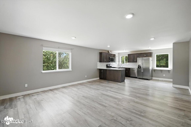 2740 S Rue De La Paix Loop, Wasilla, AK 99623 - kitchen featuring appliances with stainless steel finishes, open floor plan, dark brown cabinets, plenty of natural light, and recessed lighting