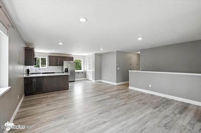 2740 S Rue De La Paix Loop, Wasilla, AK 99623 - kitchen featuring stainless steel refrigerator with ice dispenser, open floor plan, dark brown cabinetry, light countertops, and recessed lighting