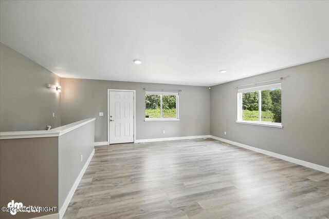 2740 S Rue De La Paix Loop, Wasilla, AK 99623 - unfurnished room featuring plenty of natural light and wood finished floors