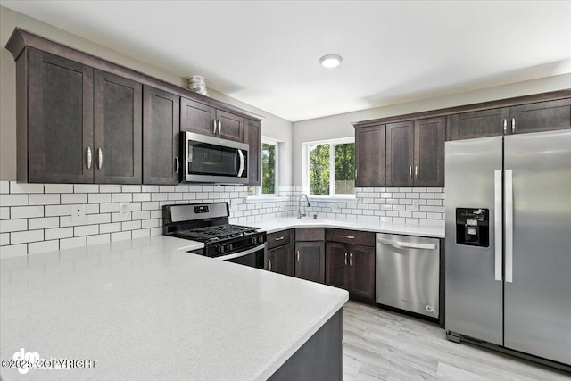 2740 S Rue De La Paix Loop, Wasilla, AK 99623 - kitchen with stainless steel appliances, dark brown cabinets, and light countertops