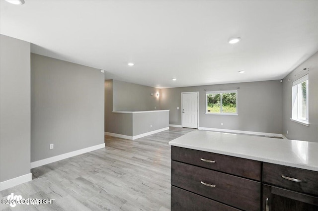 2740 S Rue De La Paix Loop, Wasilla, AK 99623 - kitchen with light wood-type flooring, light countertops, dark brown cabinets, recessed lighting, and open floor plan