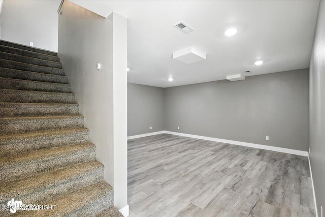 2740 S Rue De La Paix Loop, Wasilla, AK 99623 - stairway featuring wood finished floors and recessed lighting