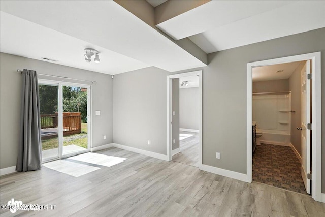 2740 S Rue De La Paix Loop, Wasilla, AK 99623 - unfurnished bedroom with wood finished floors, access to outside, and a walk in closet