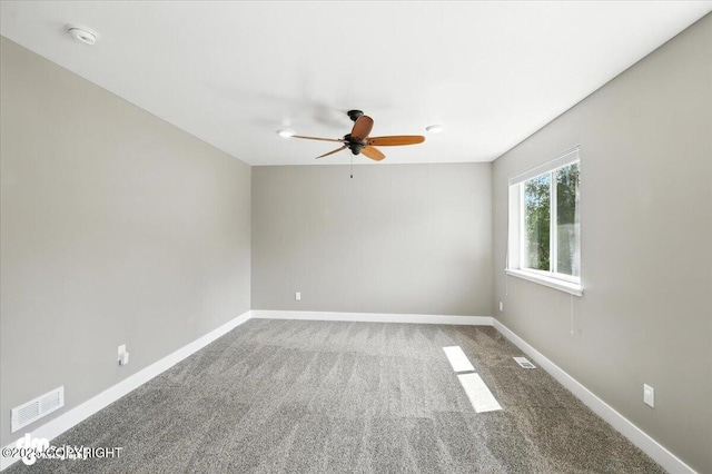 2740 S Rue De La Paix Loop, Wasilla, AK 99623 - empty room with a ceiling fan, carpet floors, and a smoke detector
