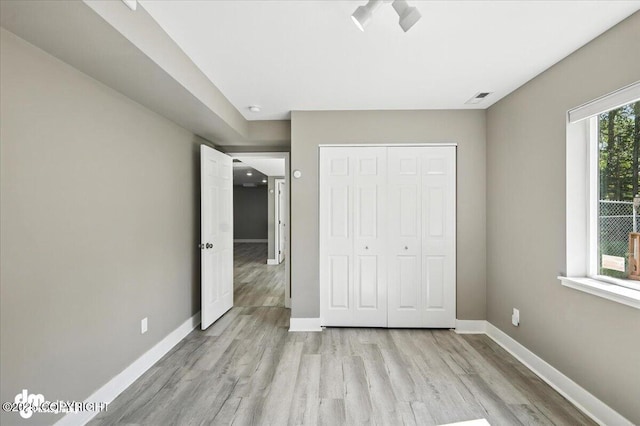 2740 S Rue De La Paix Loop, Wasilla, AK 99623 - unfurnished bedroom with light wood-style floors and a closet