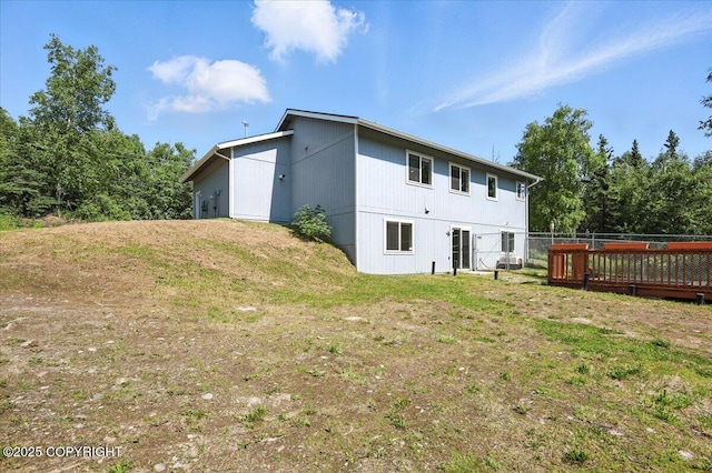 2740 S Rue De La Paix Loop, Wasilla, AK 99623 - back of property with a lawn and a wooden deck