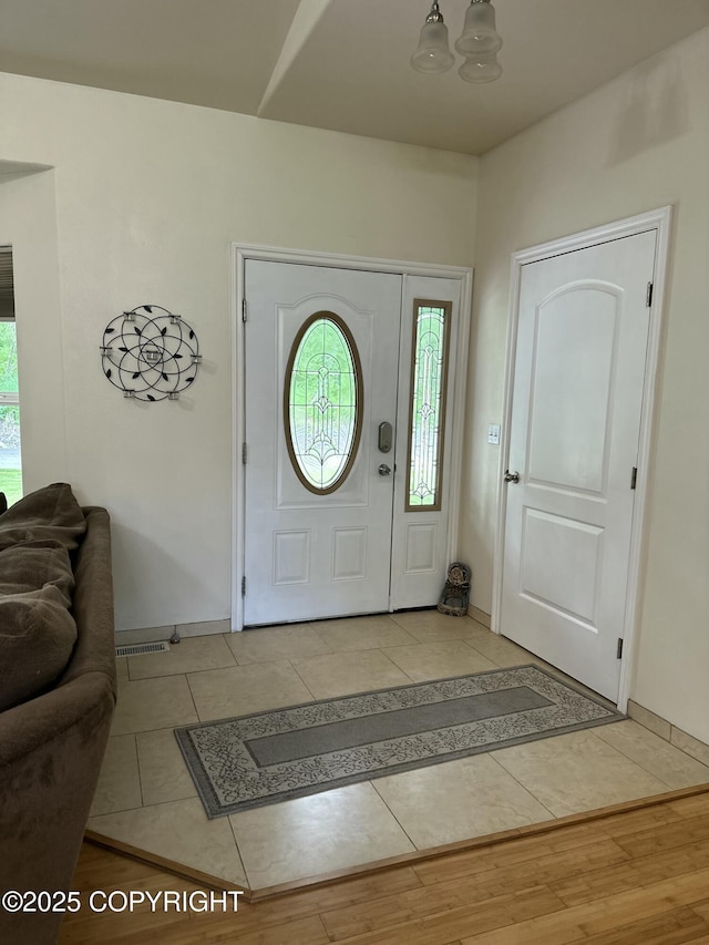 19343 Alma Ave, Chugiak, AK 99567 - foyer with light tile patterned floors and baseboards