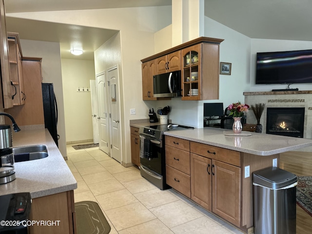 19343 Alma Ave, Chugiak, AK 99567 - kitchen with range with electric cooktop, stainless steel microwave, vaulted ceiling, glass insert cabinets, and light countertops