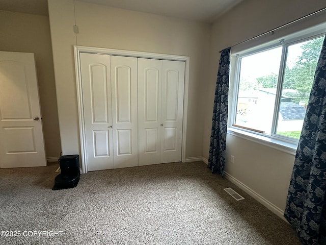 19343 Alma Ave, Chugiak, AK 99567 - unfurnished bedroom with multiple windows, carpet, and a closet