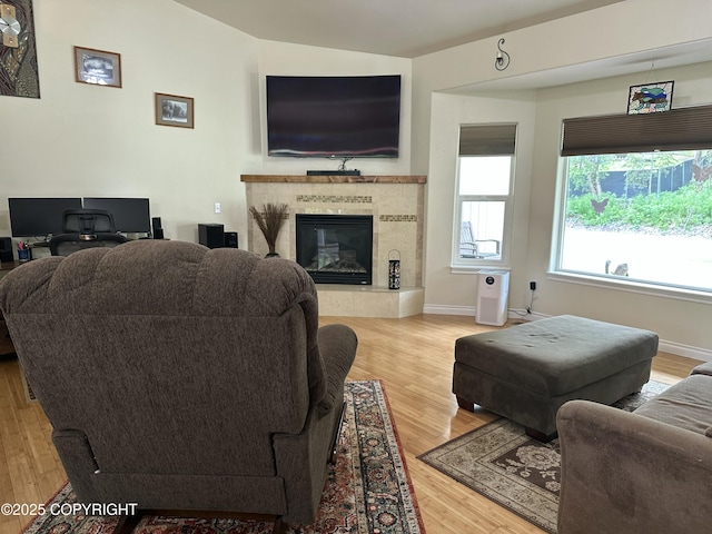 19343 Alma Ave, Chugiak, AK 99567 - living area featuring light wood-style floors, vaulted ceiling, and a tile fireplace