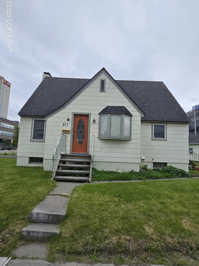 811 K St, Anchorage, AK 99501 - bungalow-style house with roof with shingles, a front lawn, and a chimney