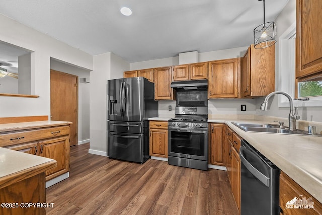 645 W Sarahs Way, Wasilla, AK 99654 - kitchen with appliances with stainless steel finishes, under cabinet range hood, light countertops, dark wood finished floors, and brown cabinets