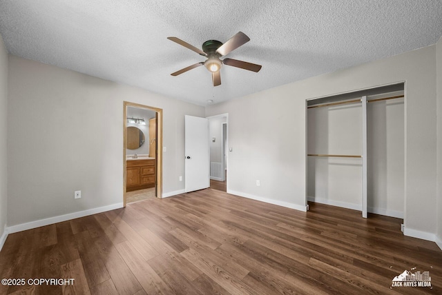 645 W Sarahs Way, Wasilla, AK 99654 - unfurnished bedroom featuring wood finished floors, a textured ceiling, a closet, ensuite bath, and ceiling fan