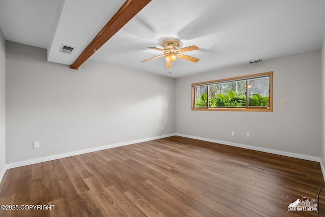 645 W Sarahs Way, Wasilla, AK 99654 - unfurnished room featuring ceiling fan, wood finished floors, and beam ceiling