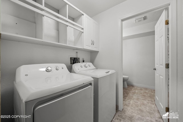 645 W Sarahs Way, Wasilla, AK 99654 - laundry room featuring cabinet space, washer and clothes dryer, and stone finish floors