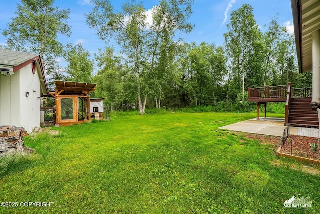 645 W Sarahs Way, Wasilla, AK 99654 - view of green lawn featuring a patio area, a wooden deck, and stairs