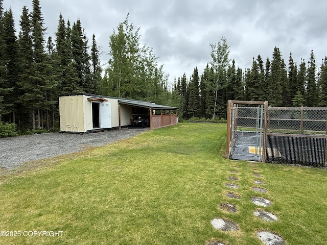 39740 Billikin St, Sterling, AK 99672 - view of yard with a carport, a view of trees, and gravel driveway