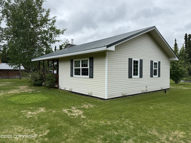 39740 Billikin St, Sterling, AK 99672 - view of side of home featuring a lawn, a metal roof, and a chimney