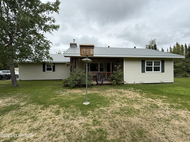 39740 Billikin St, Sterling, AK 99672 - back of property featuring a lawn, a metal roof, and covered porch