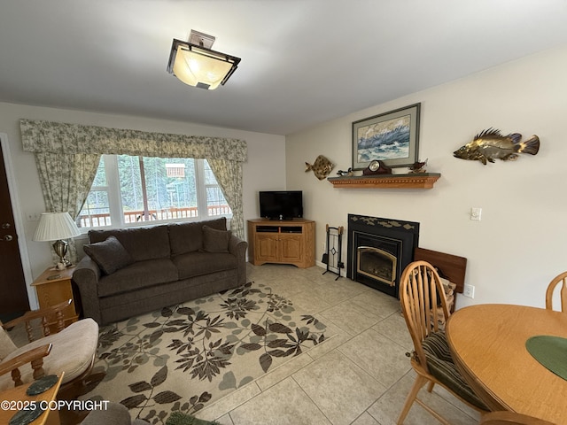 39740 Billikin St, Sterling, AK 99672 - living area featuring light tile patterned floors and a glass covered fireplace