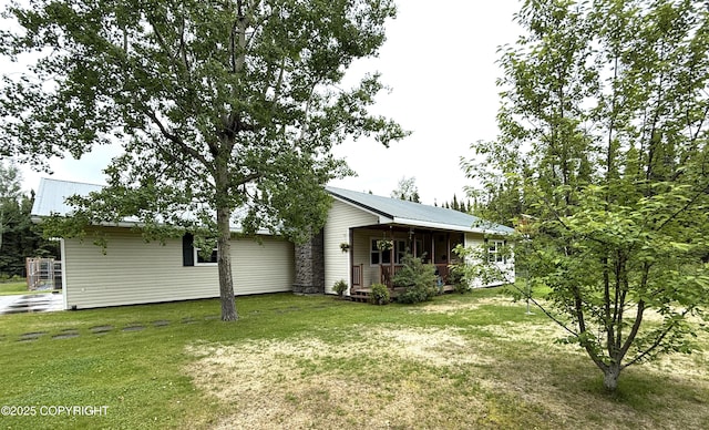 39740 Billikin St, Sterling, AK 99672 - back of property featuring a lawn, a metal roof, and covered porch
