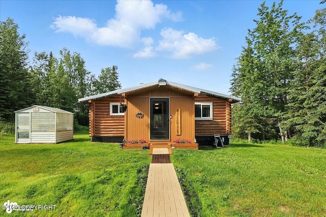 48416 Bernice Lake Rd, Nikiski/North Kenai, AK 99611 - log home featuring log exterior, an exterior structure, a front yard, and an outdoor structure