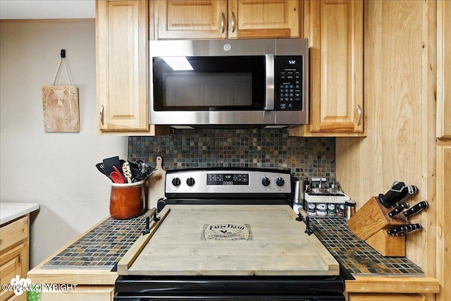 48416 Bernice Lake Rd, Nikiski/North Kenai, AK 99611 - kitchen featuring stainless steel appliances, tasteful backsplash, light brown cabinets, and light countertops