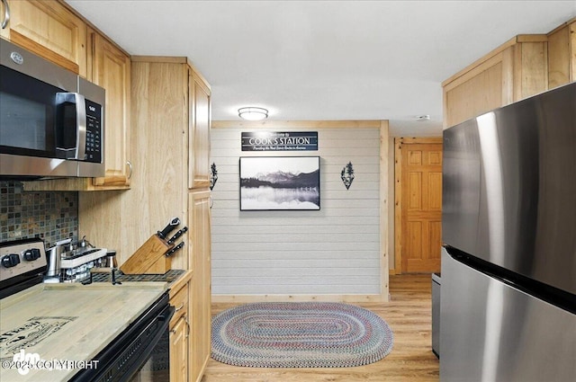 48416 Bernice Lake Rd, Nikiski/North Kenai, AK 99611 - kitchen featuring appliances with stainless steel finishes, light wood-style floors, light brown cabinets, and light countertops
