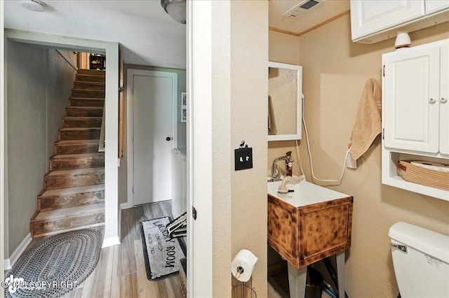 48416 Bernice Lake Rd, Nikiski/North Kenai, AK 99611 - half bath featuring toilet and wood finished floors