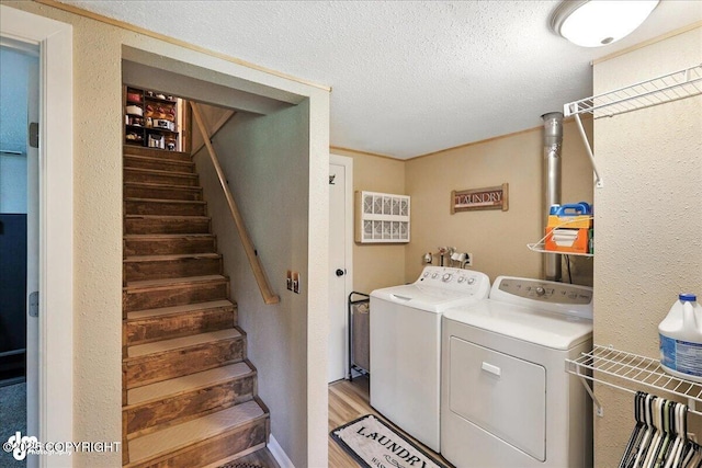 48416 Bernice Lake Rd, Nikiski/North Kenai, AK 99611 - laundry area featuring independent washer and dryer, a textured ceiling, and light wood-type flooring