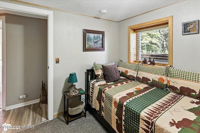48416 Bernice Lake Rd, Nikiski/North Kenai, AK 99611 - bedroom with crown molding, a textured ceiling, and wood finished floors