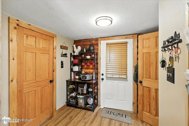 48416 Bernice Lake Rd, Nikiski/North Kenai, AK 99611 - foyer entrance with light wood-style floors and a textured ceiling