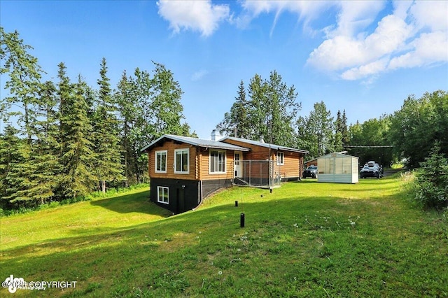 48416 Bernice Lake Rd, Nikiski/North Kenai, AK 99611 - back of house featuring a lawn and a shed