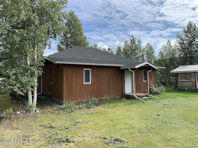 2004 N Old Steese Hwy, Fairbanks, AK 99712 - rear view of house with a lawn, an outbuilding, and roof with shingles
