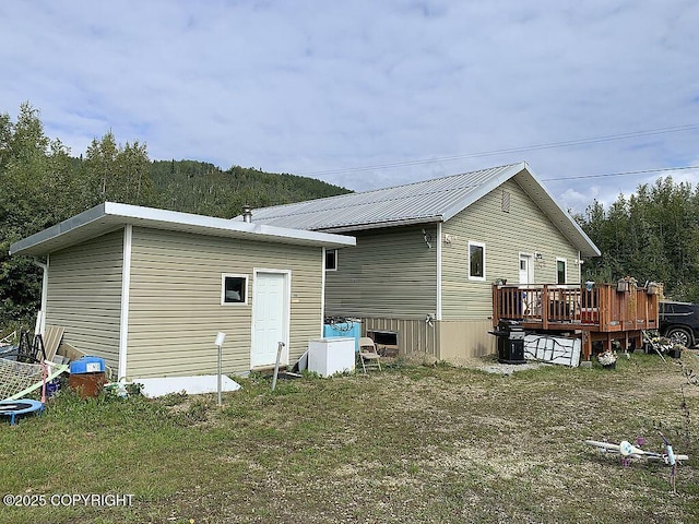 2004 N Old Steese Hwy, Fairbanks, AK 99712 - rear view of house featuring a wooden deck and a metal roof