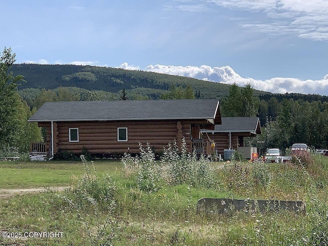 2004 N Old Steese Hwy, Fairbanks, AK 99712 - back of house featuring log exterior and a wooded view