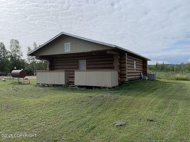 2004 N Old Steese Hwy, Fairbanks, AK 99712 - view of side of home with log exterior, a lawn, and heating fuel