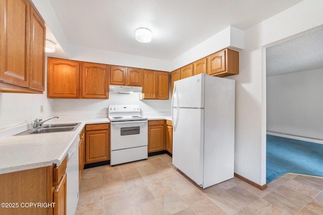8764 Trinity Dr, Juneau, AK 99801 - kitchen featuring white appliances, under cabinet range hood, light countertops, and brown cabinetry