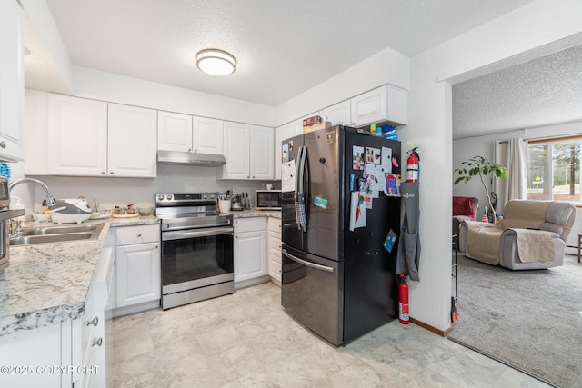 8764 Trinity Dr, Juneau, AK 99801 - kitchen with stainless steel appliances, under cabinet range hood, a textured ceiling, light countertops, and white cabinetry