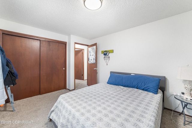 8764 Trinity Dr, Juneau, AK 99801 - bedroom featuring carpet flooring, a closet, and a textured ceiling