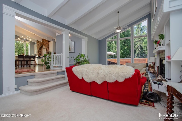 4450 Trapline Dr, Anchorage, AK 99516 - carpeted living area featuring a chandelier, a fireplace, ceiling fan, and healthy amount of natural light