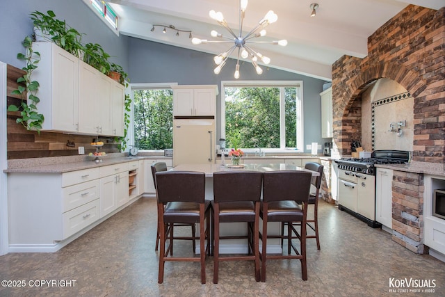 4450 Trapline Dr, Anchorage, AK 99516 - kitchen with vaulted ceiling, tasteful backsplash, a chandelier, white cabinetry, and a kitchen bar