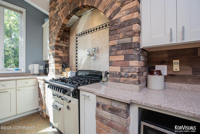 4450 Trapline Dr, Anchorage, AK 99516 - kitchen with light stone countertops, stovetop, white cabinetry, and wine cooler