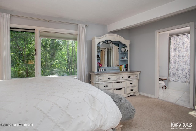 4450 Trapline Dr, Anchorage, AK 99516 - carpeted bedroom featuring ensuite bathroom and baseboards